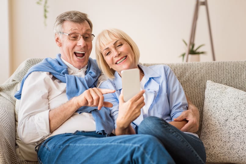 Modern Grandparents. Excited Senior Couple Making Video Call On